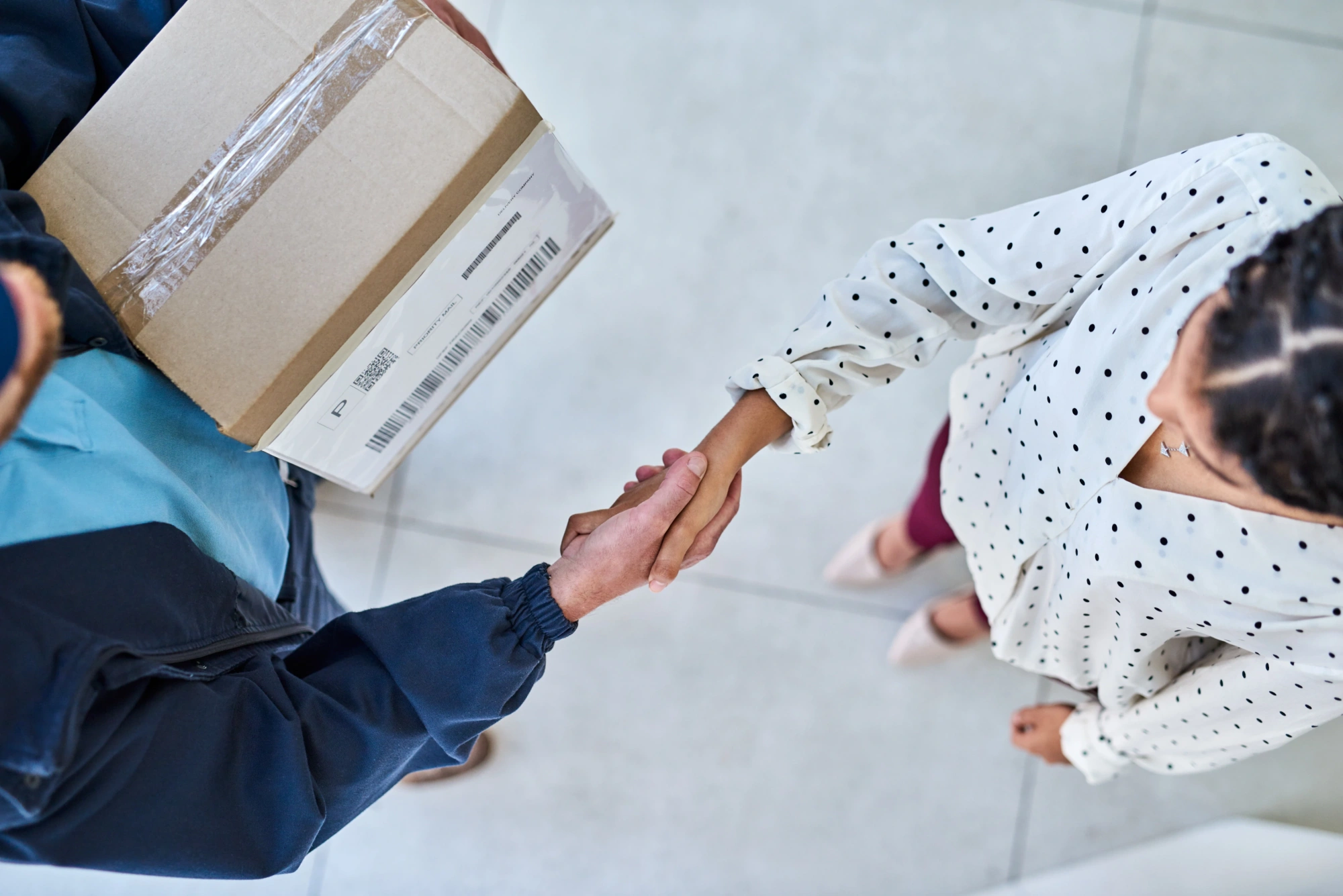 Woman shaking hands with courier